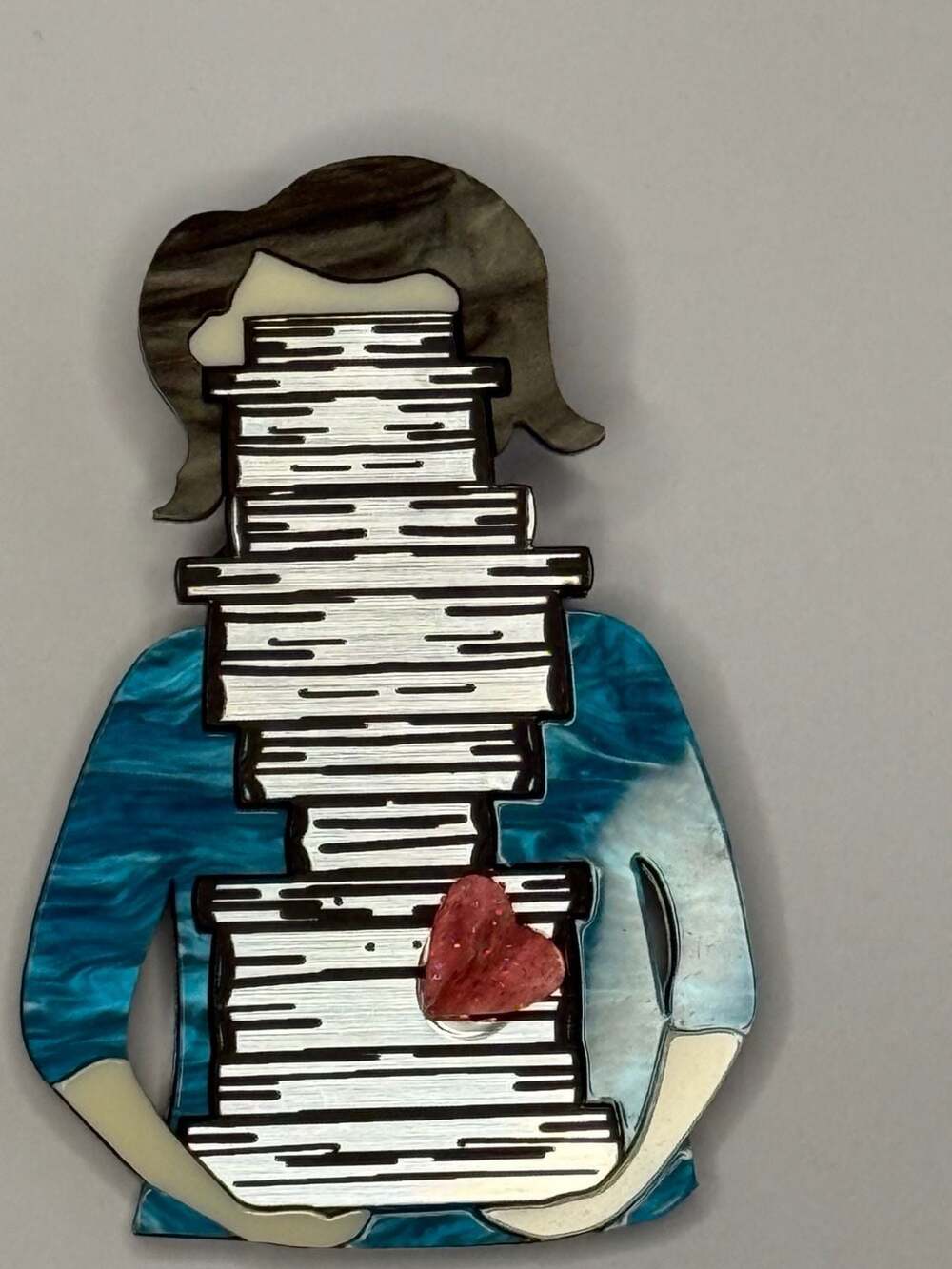 The Ottopiary Acrylic Brooch Woman Holding Stack Of Books